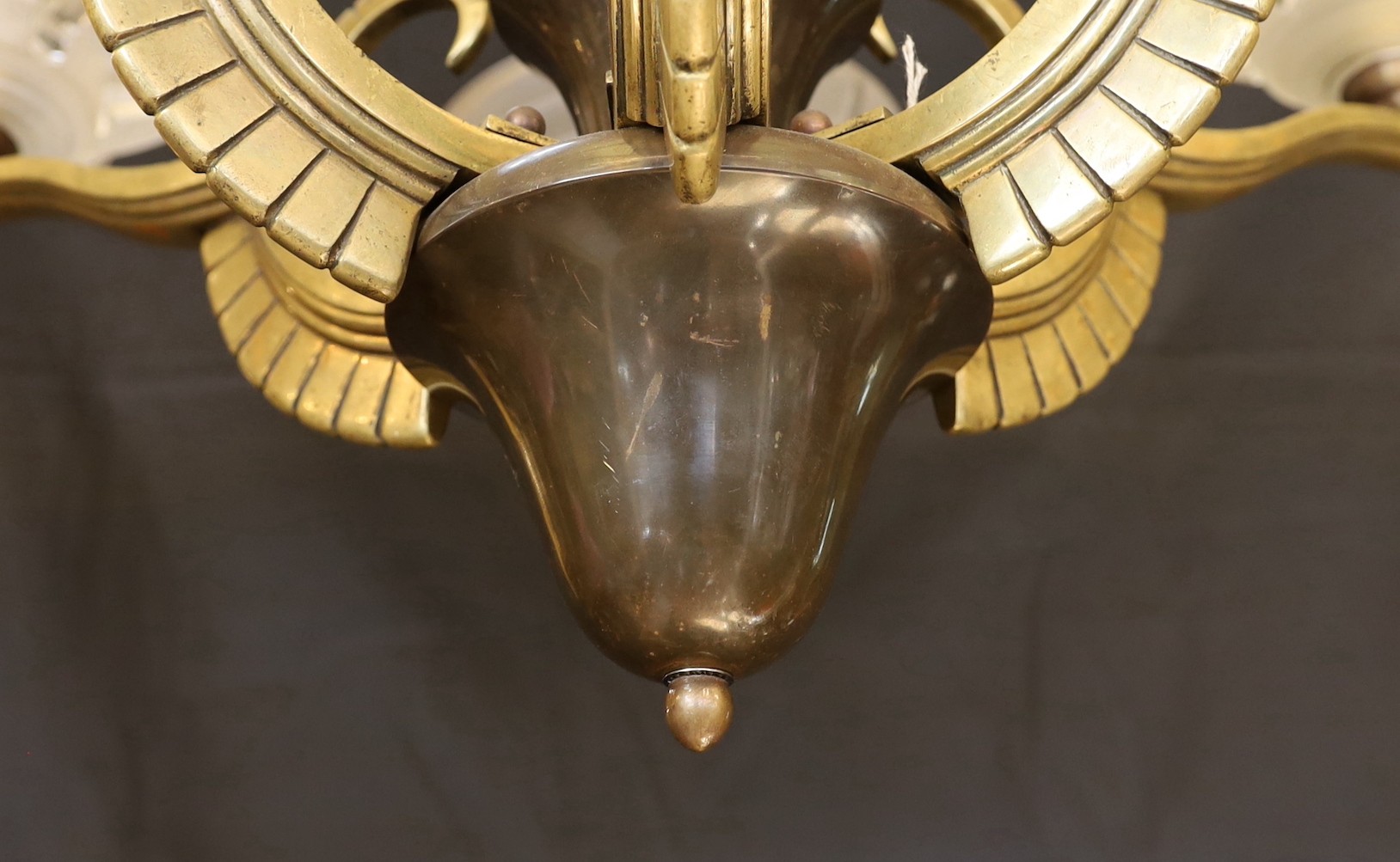 A French Art Deco bronze, hardwood and frosted glass six light chandelier, in the manner of Henri Petitot, height 64cm. width 74cm
